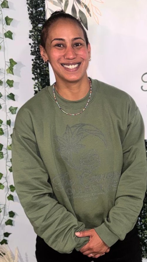 Reel still: Joa smiling in front of The Canopy Collective banner
