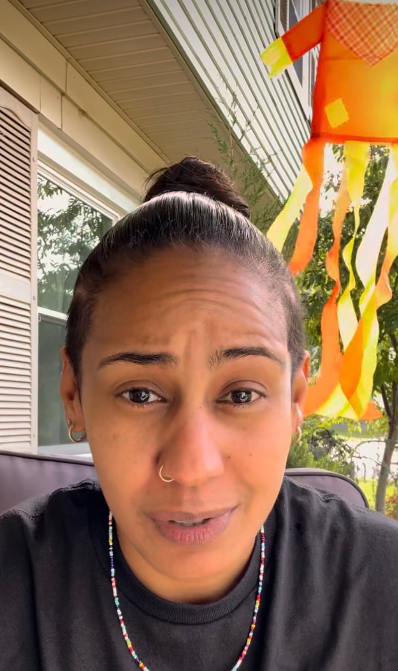 Reel still: Joa speaking to the camera on a front porch